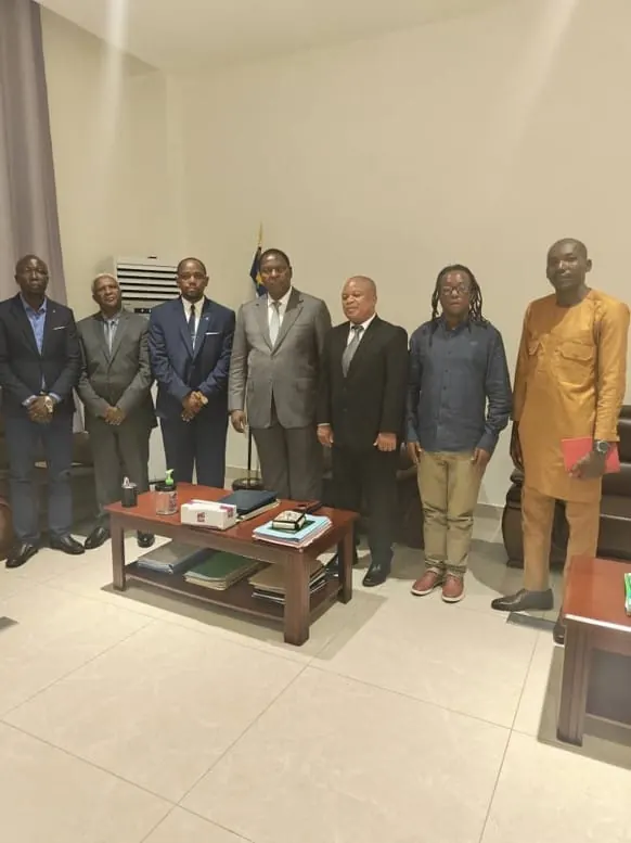 Delegation members standing together in a reception room after the presidential audience.
