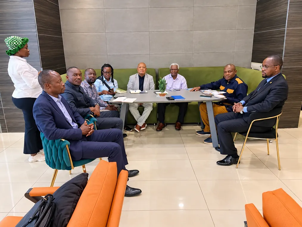 AIG and ECOROADS delegates seated around a table during a working meeting.