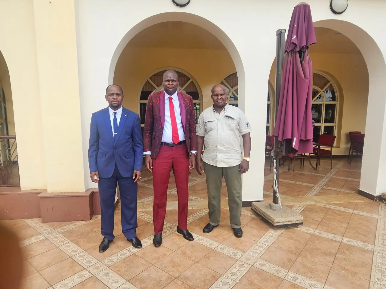 Three participants of the HEMZA AFRICA meeting standing under a colonnade.